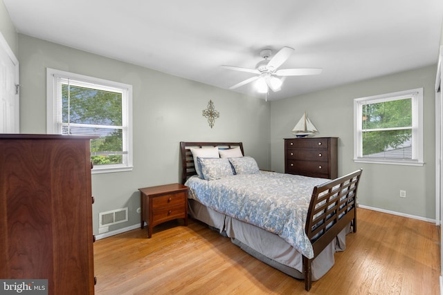 8313 Accotink Rd, Lorton, VA 22079 - bedroom with multiple windows, wood finished floors, baseboards, and a ceiling fan