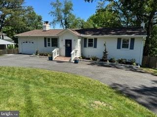 8313 Accotink Rd, Lorton, VA 22079 - ranch-style home with asphalt driveway, a chimney, and an attached garage