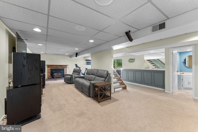 8313 Accotink Rd, Lorton, VA 22079 - carpeted living room featuring a drop ceiling, stairs, recessed lighting, and a fireplace