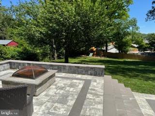 8313 Accotink Rd, Lorton, VA 22079 - view of patio / terrace with a fire pit and a playground