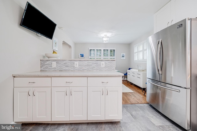600 Saint Andrews Ln, Silver Spring, MD 20901 - kitchen with freestanding refrigerator, light wood-style floors, white cabinetry, and a peninsula