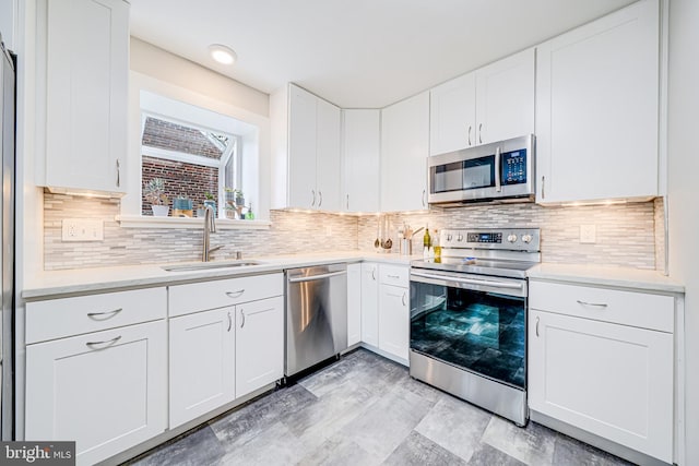 600 Saint Andrews Ln, Silver Spring, MD 20901 - kitchen featuring appliances with stainless steel finishes, a sink, light countertops, white cabinets, and decorative backsplash