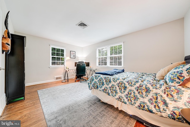 600 Saint Andrews Ln, Silver Spring, MD 20901 - bedroom with wood finished floors, multiple windows, baseboards, and a desk