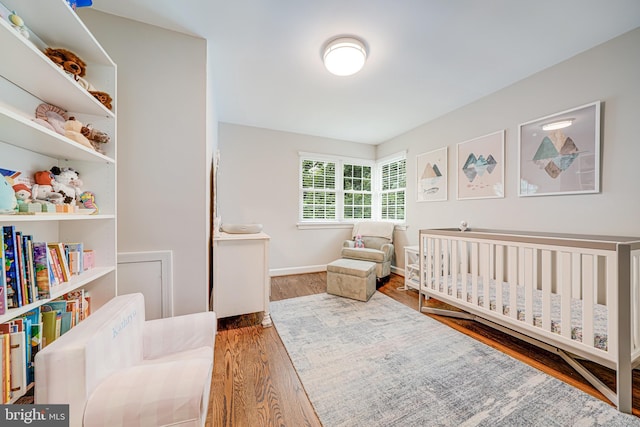 600 Saint Andrews Ln, Silver Spring, MD 20901 - bedroom with wood finished floors, a crib, and baseboards