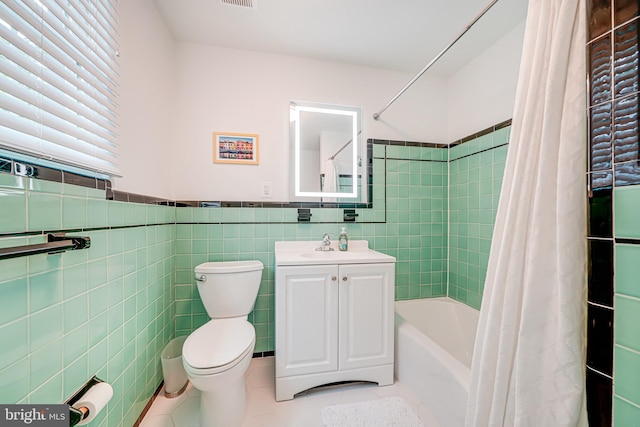 600 Saint Andrews Ln, Silver Spring, MD 20901 - bathroom with toilet, tile patterned flooring, tile walls, vanity, and shower / tub combo
