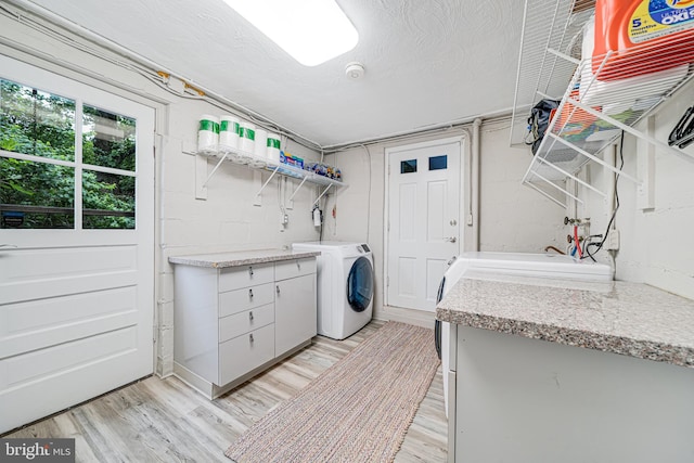 600 Saint Andrews Ln, Silver Spring, MD 20901 - laundry area with washer / dryer, light wood-style floors, cabinet space, and a textured ceiling