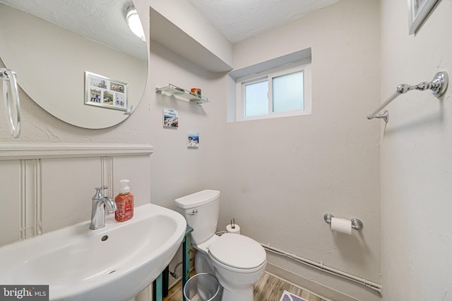 600 Saint Andrews Ln, Silver Spring, MD 20901 - half bathroom featuring toilet, wood finished floors, and a sink