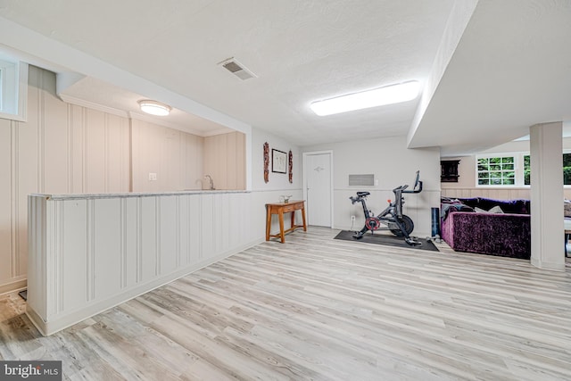600 Saint Andrews Ln, Silver Spring, MD 20901 - exercise area with wood finished floors, a decorative wall, and a textured ceiling