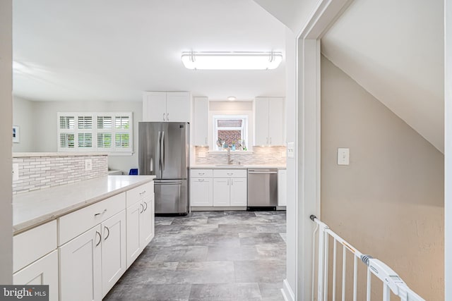 600 Saint Andrews Ln, Silver Spring, MD 20901 - kitchen featuring stainless steel appliances, a sink, decorative backsplash, and white cabinets