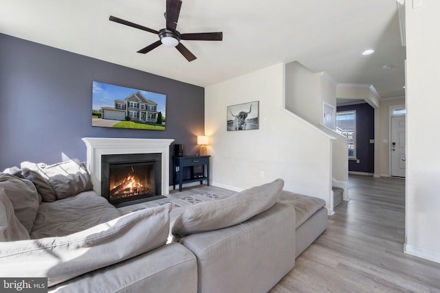 430 Mcwharton Way, Bunker Hill, WV 25413 - living room with ceiling fan, baseboards, light wood finished floors, stairs, and a lit fireplace