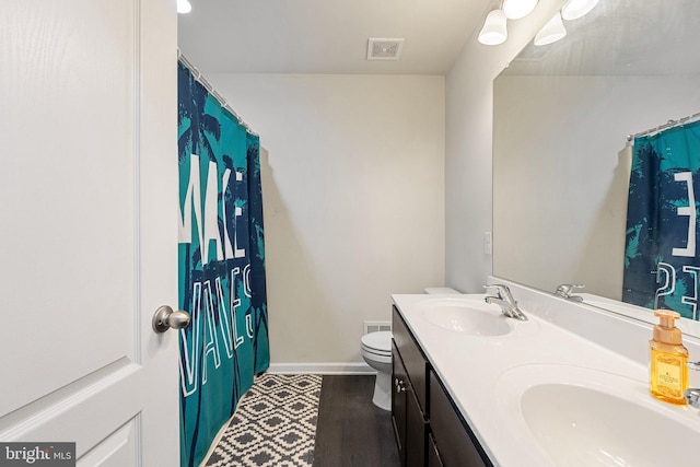 430 Mcwharton Way, Bunker Hill, WV 25413 - full bathroom featuring toilet, double vanity, baseboards, wood finished floors, and a shower with shower curtain