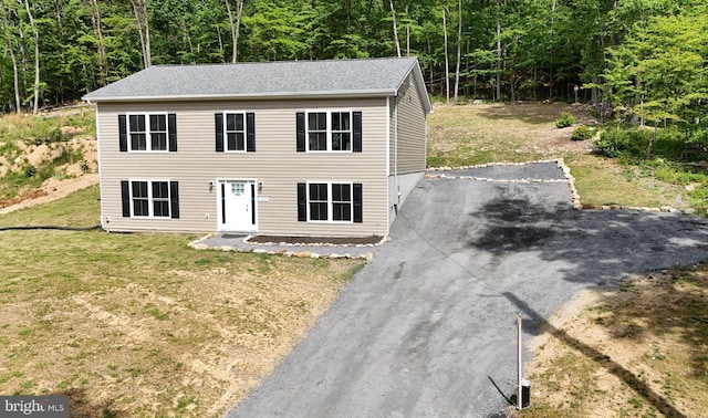 107 Arbutis Trl, Star Tannery, VA 22654 - colonial house featuring a wooded view, asphalt driveway, and a front lawn