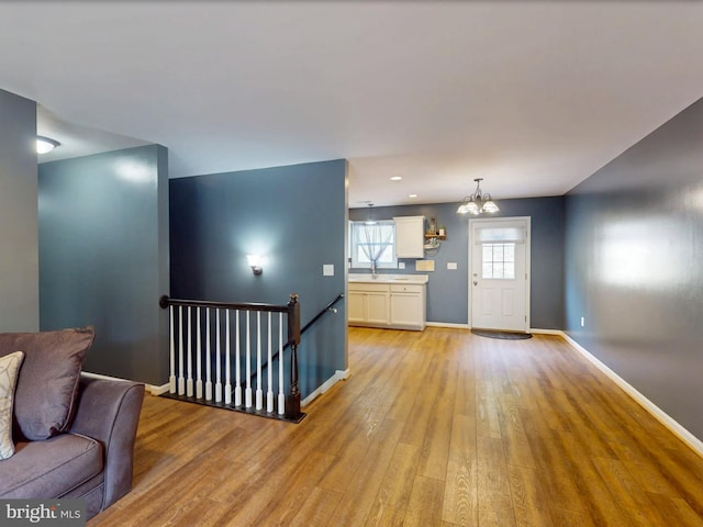 107 Arbutis Trl, Star Tannery, VA 22654 - living area with light wood-style flooring, baseboards, and a chandelier