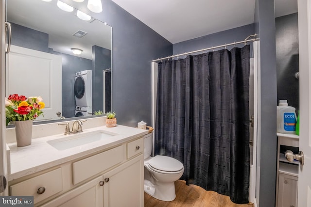 107 Arbutis Trl, Star Tannery, VA 22654 - bathroom featuring stacked washer / drying machine, toilet, vanity, wood finished floors, and a shower with curtain