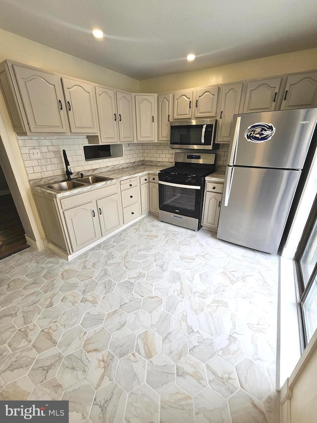 3404 Mueller St, Baltimore, MD 21224 - kitchen featuring stainless steel appliances, a sink, decorative backsplash, light countertops, and recessed lighting