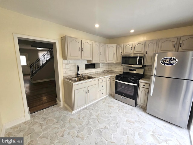 3404 Mueller St, Baltimore, MD 21224 - kitchen featuring appliances with stainless steel finishes, a sink, light countertops, decorative backsplash, and recessed lighting