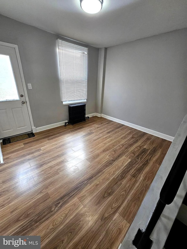 3404 Mueller St, Baltimore, MD 21224 - spare room with radiator, wood finished floors, and baseboards