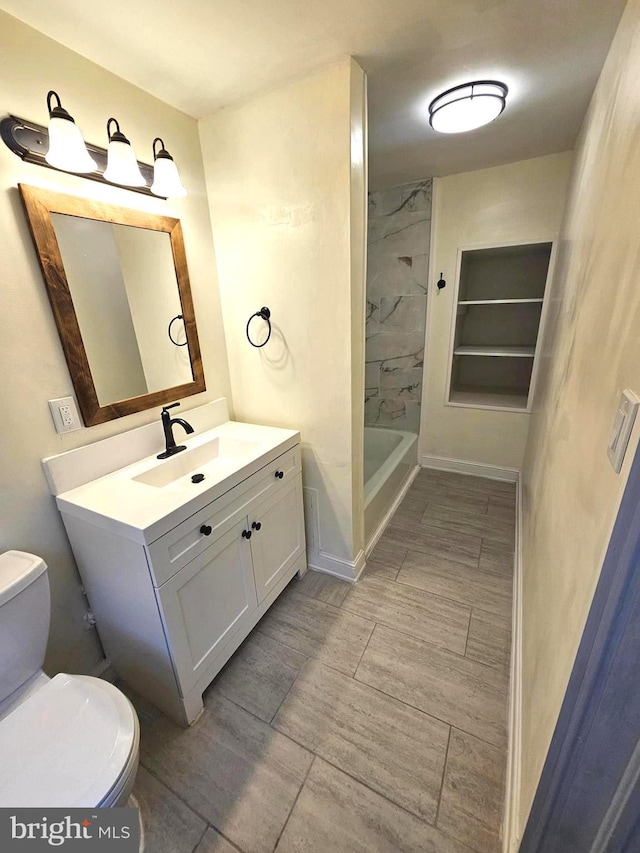 3404 Mueller St, Baltimore, MD 21224 - full bath with toilet, vanity, a shower, wood finish floors, and baseboards