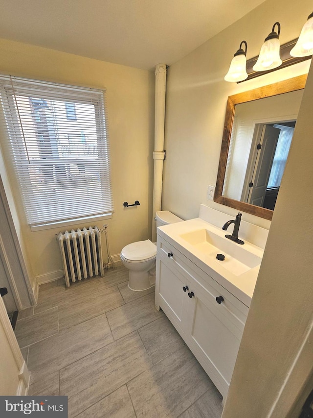 3404 Mueller St, Baltimore, MD 21224 - bathroom featuring radiator, toilet, vanity, and baseboards