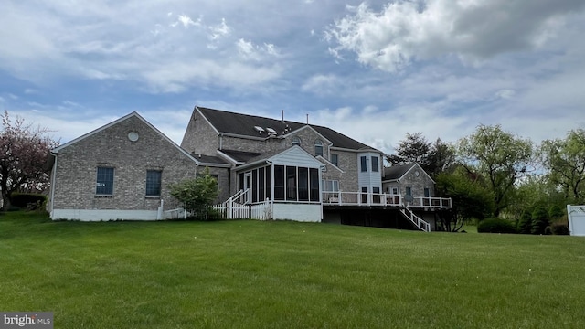 16200 Bellingham Dr, Darnestown, MD 20874 - rear view of property featuring a sunroom, a yard, brick siding, and a wooden deck