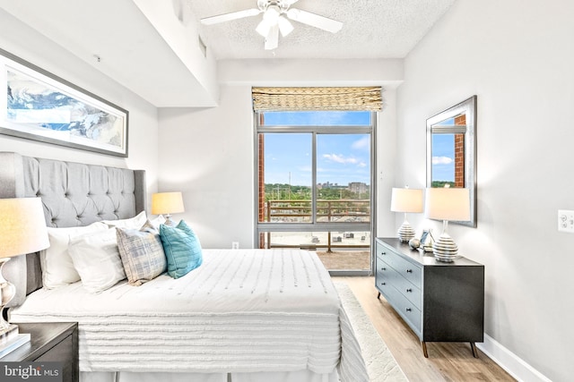 3600 S Glebe Rd Unit 605W, Arlington, VA 22202 - bedroom with light wood-style floors, a textured ceiling, baseboards, and ceiling fan