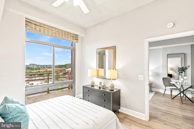 3600 S Glebe Rd Unit 605W, Arlington, VA 22202 - bedroom featuring a textured ceiling, light wood-style floors, baseboards, and a ceiling fan