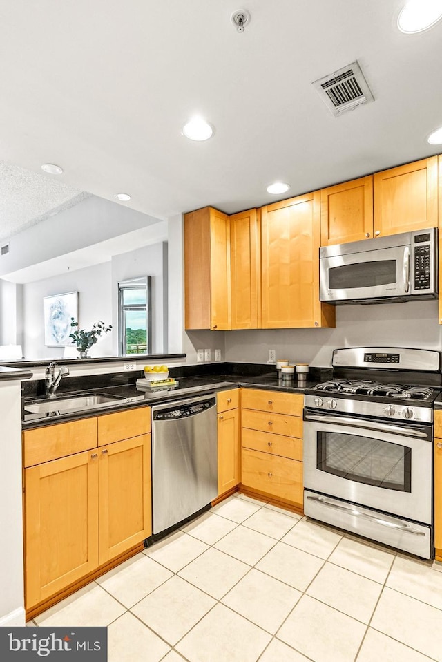 3600 S Glebe Rd Unit 605W, Arlington, VA 22202 - kitchen with appliances with stainless steel finishes, a sink, dark countertops, recessed lighting, and light tile patterned flooring