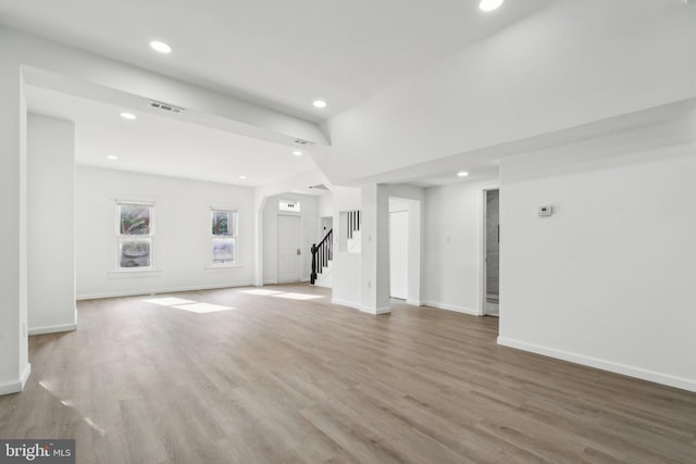 707 S Braddock St, Winchester, VA 22601 - unfurnished living room featuring stairs, light wood-style flooring, recessed lighting, and baseboards