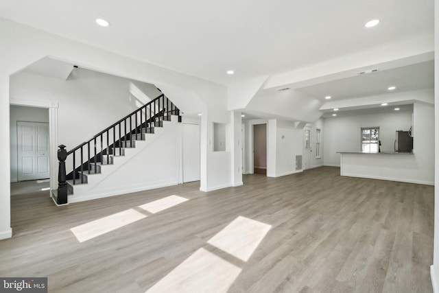 707 S Braddock St, Winchester, VA 22601 - unfurnished living room featuring stairs, recessed lighting, wood finished floors, and baseboards