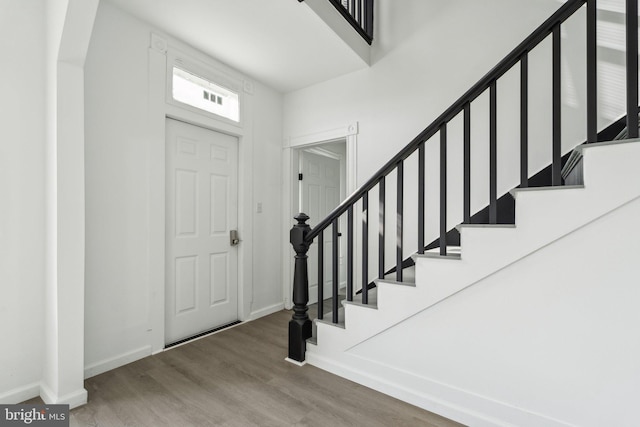 707 S Braddock St, Winchester, VA 22601 - entryway featuring baseboards, wood finished floors, stairway, and arched walkways