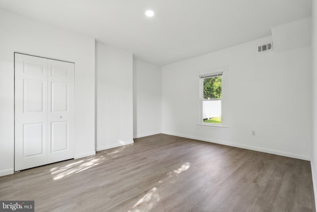 707 S Braddock St, Winchester, VA 22601 - unfurnished bedroom with wood finished floors, baseboards, and a closet