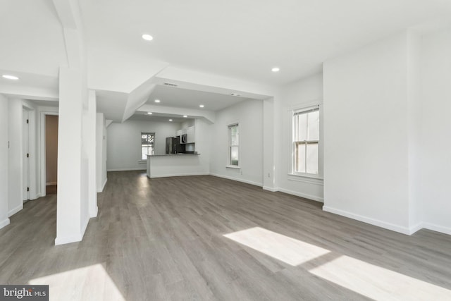 707 S Braddock St, Winchester, VA 22601 - unfurnished living room featuring baseboards, wood finished floors, and recessed lighting