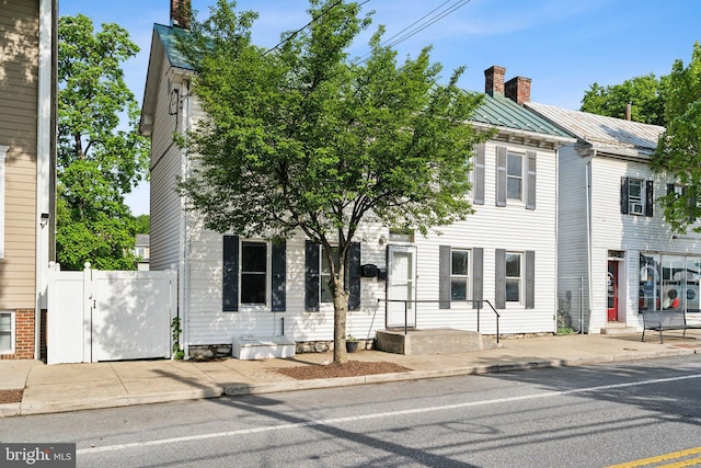 707 S Braddock St, Winchester, VA 22601 - view of front facade with a chimney, a standing seam roof, metal roof, and a gate