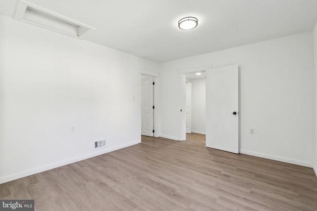 707 S Braddock St, Winchester, VA 22601 - spare room featuring attic access, light wood-style floors, and baseboards
