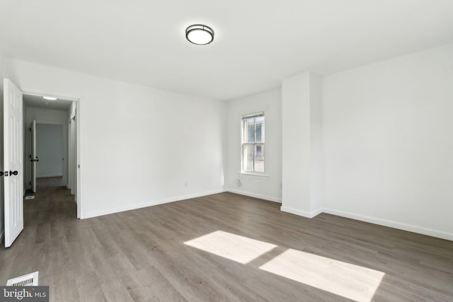 707 S Braddock St, Winchester, VA 22601 - empty room featuring wood finished floors and baseboards