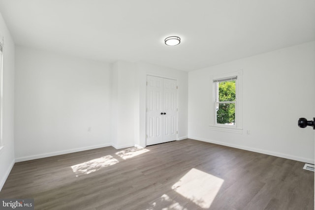 707 S Braddock St, Winchester, VA 22601 - unfurnished bedroom with wood finished floors, baseboards, and a closet