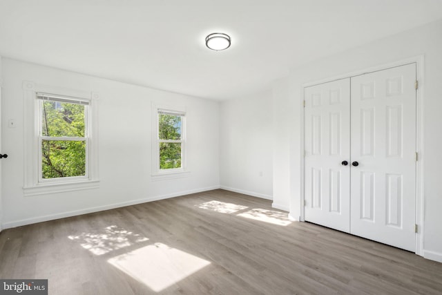 707 S Braddock St, Winchester, VA 22601 - unfurnished bedroom with wood finished floors, a closet, and baseboards
