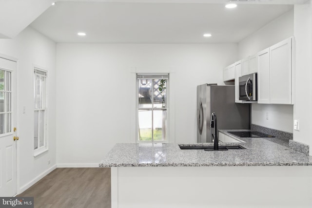 707 S Braddock St, Winchester, VA 22601 - kitchen featuring stainless steel appliances, plenty of natural light, light stone countertops, light wood-style floors, and recessed lighting