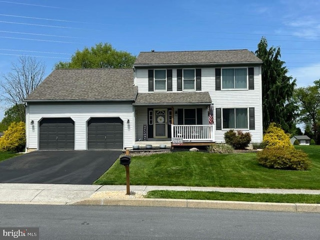 3603 Regency Dr, Reading, PA 19608 - view of front of property with a porch, a garage, driveway, and a front lawn