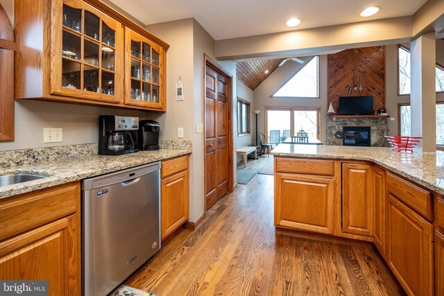 285 Cherry Heights Ln, Mc Henry, MD 21541 - kitchen featuring stainless steel dishwasher, lofted ceiling, a fireplace, glass insert cabinets, and light wood-style floors