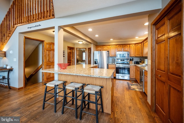 285 Cherry Heights Ln, Mc Henry, MD 21541 - kitchen with appliances with stainless steel finishes, dark wood-style flooring, light stone counters, a kitchen island, and recessed lighting