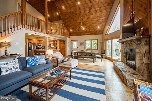 285 Cherry Heights Ln, Mc Henry, MD 21541 - living room featuring wooden ceiling, high vaulted ceiling, light wood-style floors, a ceiling fan, and a stone fireplace