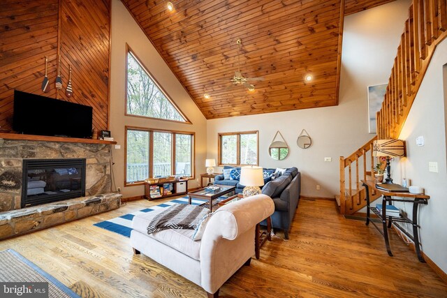 285 Cherry Heights Ln, Mc Henry, MD 21541 - living area featuring high vaulted ceiling, stairs, wood finished floors, baseboards, and a stone fireplace