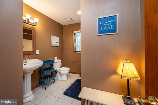 285 Cherry Heights Ln, Mc Henry, MD 21541 - half bath with tile patterned flooring, toilet, baseboards, and a textured ceiling