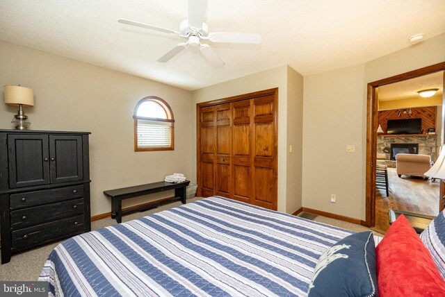 285 Cherry Heights Ln, Mc Henry, MD 21541 - carpeted bedroom with baseboards, a fireplace, a closet, and a ceiling fan