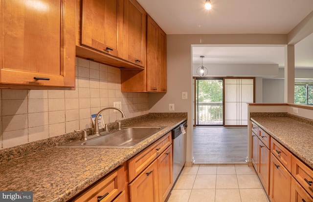 6305 Hil Mar Dr Unit 2-9, District Heights, MD 20747 - kitchen featuring stainless steel dishwasher, a sink, decorative backsplash, brown cabinets, and light tile patterned floors