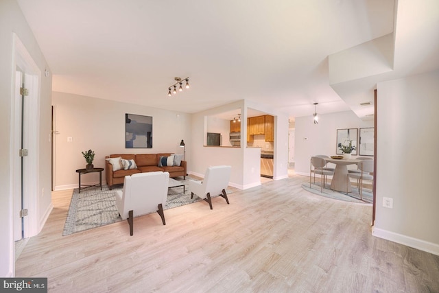 6305 Hil Mar Dr Unit 2-9, District Heights, MD 20747 - living room featuring light wood-style floors and baseboards