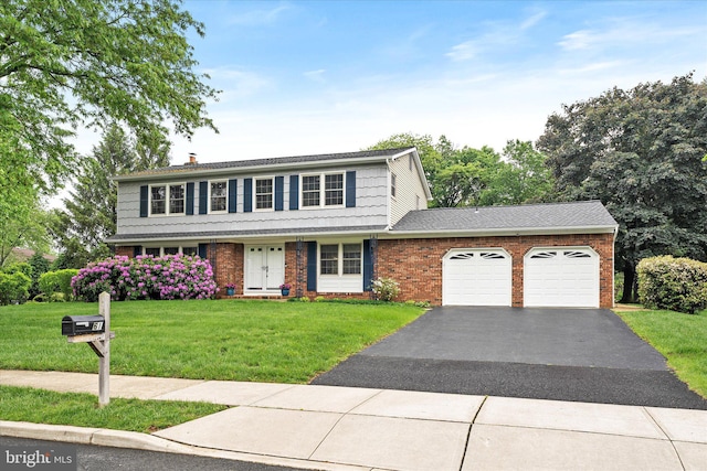 view of front of home featuring an attached garage, driveway, brick siding, a front lawn, and a chimney