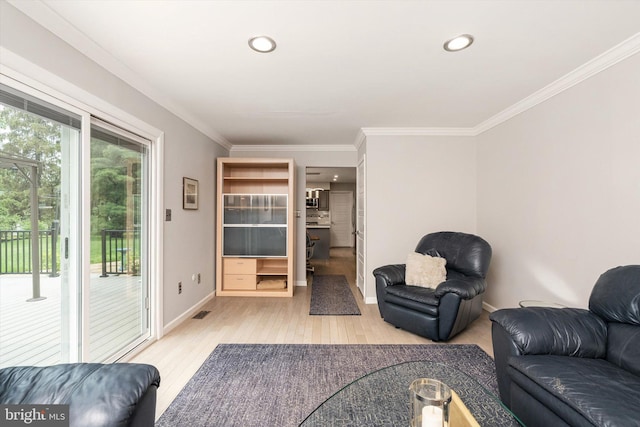 living area with ornamental molding, light wood finished floors, recessed lighting, and baseboards