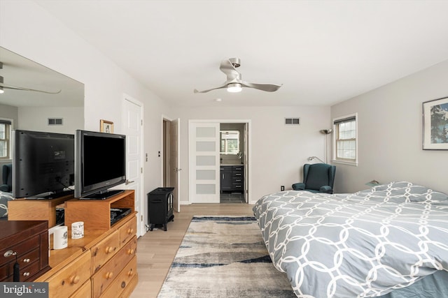 bedroom with light wood-type flooring and ceiling fan